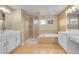 Primary bathroom featuring double sinks, a shower, and soaking tub, for a spa-like retreat at 20532 E Lake Cir, Centennial, CO 80016