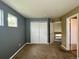 Bedroom with neutral walls and carpet flooring that features double doors to a closet at 20532 E Lake Cir, Centennial, CO 80016