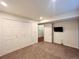 Bedroom with double closet, tan carpet, and a flat-screen TV mounted on the wall, offering a cozy and functional space at 20532 E Lake Cir, Centennial, CO 80016