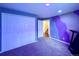 Cozy bedroom with a unique purple wall, built-in closet, and gray carpeting, creating a relaxed and inviting space at 20532 E Lake Cir, Centennial, CO 80016