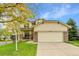 Charming two-story home featuring a front porch, brick accents, and an attached two-car garage at 20532 E Lake Cir, Centennial, CO 80016