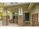 Inviting front porch with brick pillars, outdoor seating, and a welcoming front door at 20532 E Lake Cir, Centennial, CO 80016