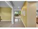Bright hallway leading to a living room with fireplace, wood floors, and decorative windows at 20532 E Lake Cir, Centennial, CO 80016