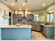 Stylish kitchen featuring granite countertops, a tile backsplash, stainless steel appliances, and modern pendant lighting at 20532 E Lake Cir, Centennial, CO 80016
