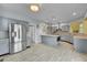 Bright, open kitchen with gray cabinets, stainless steel appliances, and wood tile flooring at 20532 E Lake Cir, Centennial, CO 80016