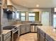 Modern kitchen with grey cabinets, granite counters, stainless steel appliances, and a tile backsplash at 20532 E Lake Cir, Centennial, CO 80016