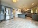Spacious kitchen with stainless steel appliances, grey cabinets, a large island, and wood-look tile flooring at 20532 E Lake Cir, Centennial, CO 80016