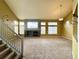 Bright living room with a fireplace, vaulted ceilings, lots of natural light, and carpeted floors for a cozy feel at 20532 E Lake Cir, Centennial, CO 80016