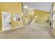 Open living area with stairs, fireplace, natural light, and view into kitchen at 20532 E Lake Cir, Centennial, CO 80016