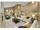 Inviting living room with vaulted ceilings, staircase, neutral decor, and comfortable seating arrangement at 20532 E Lake Cir, Centennial, CO 80016