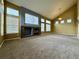 Spacious living room with vaulted ceilings, a stone fireplace, and large windows for ample natural light at 20532 E Lake Cir, Centennial, CO 80016