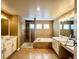 Spacious primary bathroom featuring dual vanities, a glass-enclosed shower, and a soaking tub at 20532 E Lake Cir, Centennial, CO 80016