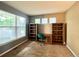 Home office with a large window, custom bookshelves, and neutral color scheme at 20532 E Lake Cir, Centennial, CO 80016