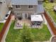 Aerial view showcases a well-maintained backyard with a patio, gazebo, and privacy fence at 5733 S Yakima Way, Aurora, CO 80015