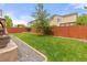 Green backyard with a well-maintained lawn and privacy fence provides a serene outdoor retreat at 5733 S Yakima Way, Aurora, CO 80015