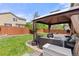 Lush backyard featuring a manicured lawn, privacy fence, and patio with cozy outdoor seating under a gazebo at 5733 S Yakima Way, Aurora, CO 80015