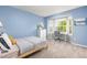 Stylish bedroom featuring a bed, desk area, and a bright blue color scheme at 5733 S Yakima Way, Aurora, CO 80015