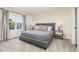 Cozy bedroom with a comfortable bed, stylish lamps, and a window with natural light at 5733 S Yakima Way, Aurora, CO 80015