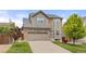 Charming two-story home with a brick and siding exterior, a two-car garage, and a well-kept front lawn at 5733 S Yakima Way, Aurora, CO 80015