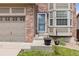 Inviting front porch with potted flowers, enhancing the curb appeal of this charming home at 5733 S Yakima Way, Aurora, CO 80015
