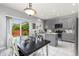 Bright, open kitchen with stainless steel appliances and a view to the dining area at 5733 S Yakima Way, Aurora, CO 80015