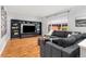 Spacious living room featuring a large sectional sofa, built-in shelving, and hardwood floors at 5733 S Yakima Way, Aurora, CO 80015