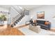 Living room with hardwood floors, stairs, contemporary furniture, and natural light at 5733 S Yakima Way, Aurora, CO 80015