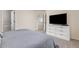Main bedroom with a large TV and ample storage in the white dresser at 5733 S Yakima Way, Aurora, CO 80015