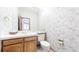 Small bathroom with tiled wall, tile floor, vanity, sink and a toilet at 9873 Greensview Cir, Lone Tree, CO 80124