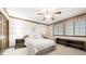 Neutral bedroom features a large window, ceiling fan, and traditional decor at 9873 Greensview Cir, Lone Tree, CO 80124