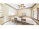 Spacious dining room featuring white walls and a table with seating for six under a ceiling fan at 9873 Greensview Cir, Lone Tree, CO 80124