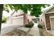 Charming home exterior featuring a brick facade, attached garage, and inviting courtyard at 9873 Greensview Cir, Lone Tree, CO 80124