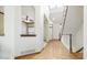 Light-filled foyer with hardwood floors and a staircase leading to the upper level at 9873 Greensview Cir, Lone Tree, CO 80124