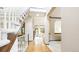 Inviting foyer features a staircase and light hardwood floors at 9873 Greensview Cir, Lone Tree, CO 80124