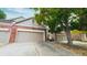 Home's exterior showcasing the garage, brick facade, and lush greenery at 9873 Greensview Cir, Lone Tree, CO 80124