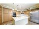 Traditional kitchen featuring wood cabinets, white countertops, and stainless steel refrigerator at 9873 Greensview Cir, Lone Tree, CO 80124