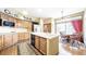 Traditional kitchen with wood cabinets, center island, white tile, and a breakfast nook at 9873 Greensview Cir, Lone Tree, CO 80124