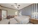 Bedroom featuring wood trim, blue striped wallpaper, and a large bed at 9873 Greensview Cir, Lone Tree, CO 80124