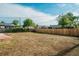 Large, unfenced backyard with fresh dirt, mature trees, and a sunny disposition at 3055 Carson St, Aurora, CO 80011