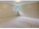Bright, carpeted bedroom with large corner windows offering ample natural light and backyard views at 3055 Carson St, Aurora, CO 80011