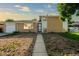 Charming brick home with an attached garage and low-maintenance front yard landscaping at 3055 Carson St, Aurora, CO 80011