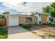 Charming brick home with an attached garage and an expansive concrete driveway at 3055 Carson St, Aurora, CO 80011