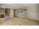 Spacious living room featuring hardwood floors, neutral paint, large window and stairs to the second level at 3055 Carson St, Aurora, CO 80011