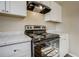 New black electric oven and range with white cabinets at 3055 Carson St, Aurora, CO 80011