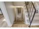 View of carpeted staircase with metal railing leading to lower level hallway with wood-look vinyl flooring at 3055 Carson St, Aurora, CO 80011
