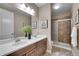 Updated bathroom featuring double sinks, stone tile and framed mirrors at 27615 E Moraine Dr, Aurora, CO 80016