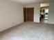 Bedroom featuring closet doors with a mirrored vanity and an open floor plan leading to the kitchen at 13601 E Marina Dr # 508, Aurora, CO 80014