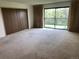 Bedroom with a sliding glass door to a balcony, neutral carpet and a closet with plenty of room for furniture and personal items at 13601 E Marina Dr # 508, Aurora, CO 80014