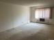 Neutral bedroom featuring large windows and a wall AC unit at 13601 E Marina Dr # 508, Aurora, CO 80014