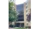 Apartment building featuring a grand two-story entrance with floor-to-ceiling windows, exterior landscaping, and clearly visible signage at 13601 E Marina Dr # 508, Aurora, CO 80014